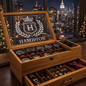 May include: Wooden watch box with the name "HAMILTON" on the lid. The box is open, revealing several watches in the top compartment and jewelry in the bottom drawer. The background includes a city skyline and a Christmas tree.