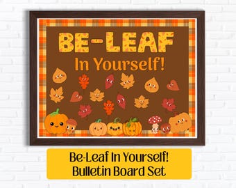 May include: A rectangular bulletin board set featuring a dark brown background with the text BE-LEAF In Yourself! in yellow. The design includes various cartoon autumn leaves, pumpkins, mushrooms, and acorns, all framed by an orange plaid border.