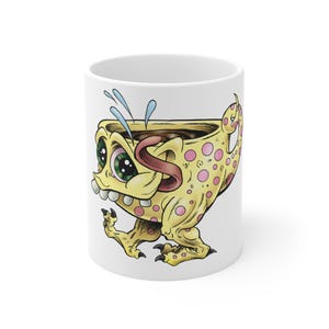 May include: White ceramic coffee mug featuring a cartoon monster design. The yellow monster has pink polka dots, a long tongue, and green eyes. The mug is filled with a dark liquid and has blue water droplets.