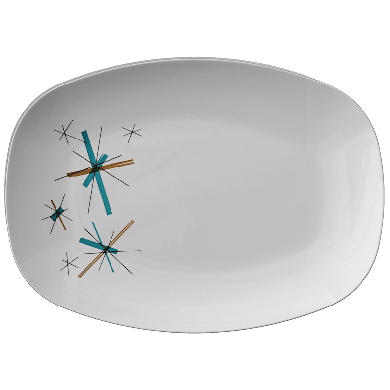 May include: White oval serving platter with a mid-century modern design featuring teal and brown starbursts.