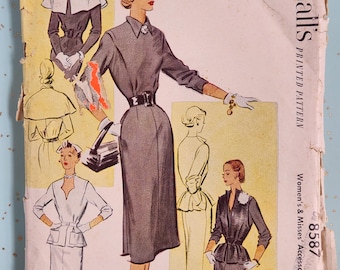 May include: Vintage McCall's sewing pattern for a women's accessory dress. The pattern is for sizes 34 to 38 bust and is numbered 8587. The pattern shows a woman wearing a gray dress with a black belt and a white blouse.