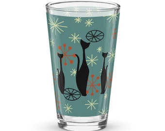 May include: A teal blue glass with a retro design featuring black cats and orange and white starbursts.
