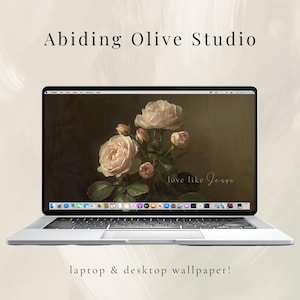 May include: A silver laptop displays a floral wallpaper featuring light pink roses. The screen shows the text "love like Jeana". The words "Abiding Olive Studio" and "laptop & desktop wallpaper!" are also visible.