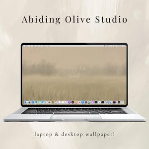 May include: A silver laptop displaying a desktop wallpaper with a landscape scene and the words "glory to God." The laptop is open, with the text "Abiding Olive Studio" above it and "laptop & desktop wallpaper!" below.
