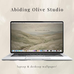 May include: A silver laptop showing a landscape wallpaper with the text "the Creator calls me His." The laptop is on a light beige background with the text "Abiding Olive Studio" and "laptop & desktop wallpaper!"