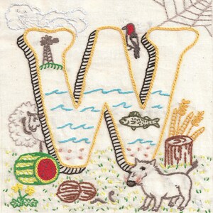 May include: Embroidered letter W with a yellow outline and brown stitching. The letter is filled with various images, including a windmill, a river, a fish, a pig, a watermelon, and wheat stalks.