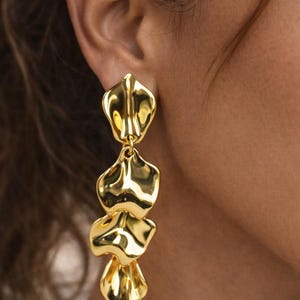 Macro shot of the jewelry-grade acrylic leaf with a durable gold-plated finish, highlighting the premium 'molten gold' textured surface.