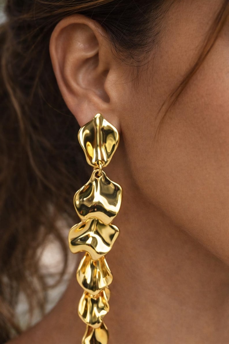 Macro shot of the jewelry-grade acrylic leaf with a durable gold-plated finish, highlighting the premium 'molten gold' textured surface.