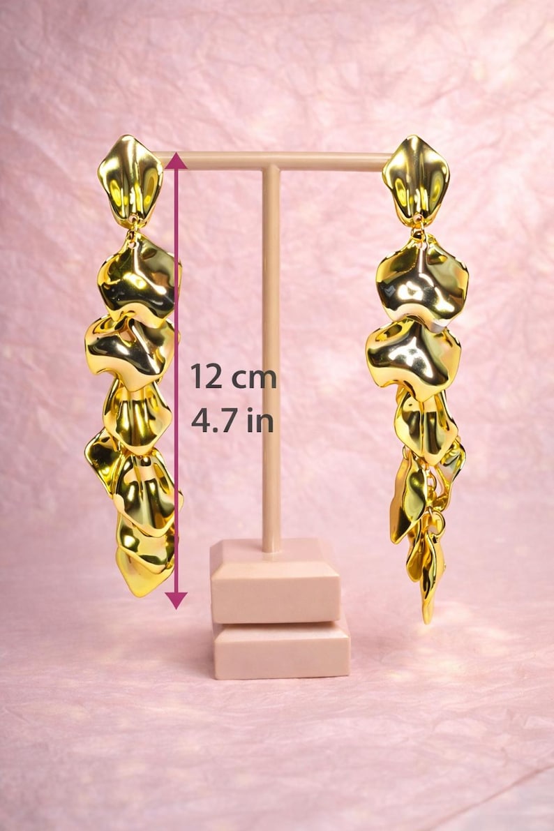 Large gold leaf dangles placed next to a ruler to demonstrate their impressive 12cm (4.7 inch) statement length.
