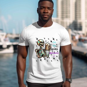 May include: White t-shirt with a colourful skeleton design holding a beer stein. The text "On my WURS Behavio r" is included. Black star accents surround the skeleton. This is a casual wear item.