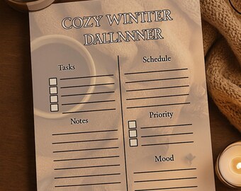 May include: A printed planner with the text "COZY WINTER DALLNNER" features sections for tasks, schedule, notes, priority, and mood. A mug of hot chocolate with marshmallows, a candle, and glasses rest nearby on a wooden surface.