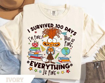 May include: Ivory-colored t-shirt with the text "I SURVIVED 100 DAYS, I'M FINE, THIS IS FINE, EVERYTHING IS FINE." Features a cartoon character with books, an apple, a globe, and pencils. The shirt is a Comfort Colors brand.