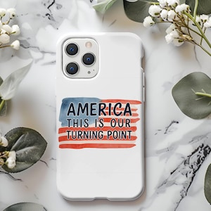 May include: White phone case with the text "AMERICA THIS IS OUR TURNING POINT" in blue and red, resembling the American flag. The case has a glossy finish and a camera cutout.