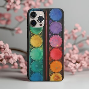 May include: A phone case with a watercolour paint palette design. The case shows a vibrant array of colours, including blue, green, yellow, orange, and red, with a paintbrush in the centre. The case is designed to fit a smartphone.