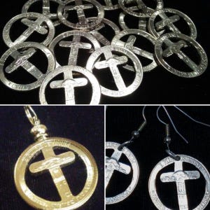 May include: A collection of silver-toned metal coin cutouts shaped like crosses, featuring the text E PLURIBUS UNUM and UNITED STATES OF AMERICA. The set includes a single pendant with a bail and a pair of earrings with silver-toned metal hooks.