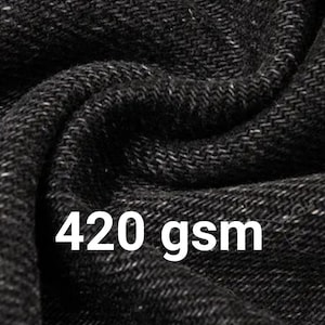 May include: A close-up view of black fabric with a visible woven texture and folds. The text 420 gsm is printed in white over the fabric, indicating the weight of the material in grams per square meter, which is a standard metric measurement.