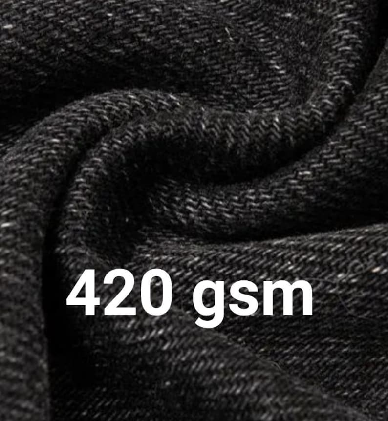 May include: A close-up view of black fabric with a visible woven texture and folds. The text 420 gsm is printed in white over the fabric, indicating the weight of the material in grams per square meter, which is a standard metric measurement.