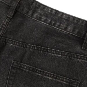 May include: A pair of black denim jeans featuring a high-waisted design with a structured waistband, belt loops, and a visible back pocket. The fabric has a washed-out, charcoal-toned texture with reinforced stitching along the seams and pockets.