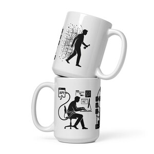 May include: Two white ceramic mugs stacked. The top mug has a black silhouette of a person walking with a key. The bottom mug features a black silhouette of a person working on a computer, with API text.