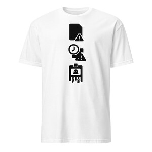 May include: White t-shirt with a black graphic design. The design includes a file icon with an exclamation mark, a clock, and a computer monitor with a ghost and a bug. The shirt has short sleeves and a crew neck.