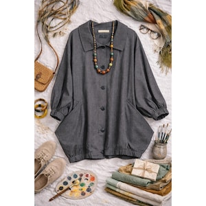 May include: A gray, vertically striped jacket with large pockets and a button-up front. The jacket has a wide collar and long sleeves. A colorful beaded necklace is draped over the jacket. Accessories include a small purse, bracelets, shoes, and a scarf.