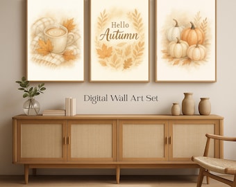 Könnte beinhalten: Ein Set aus drei gerahmten digitalen Wandkunstdrucken mit Herbstthema. Die Drucke zeigen eine Tasse Kaffee, den Text "Hello Autumn" und Kürbisse. Die Drucke sind in warmen Tönen von Beige, Orange und Braun gehalten. Der Text "Digital Wall Art Set" steht darunter.