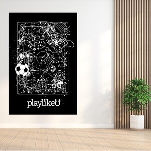 May include: Black and white soccer-themed art print. The artwork features a soccer ball and a diagram of a soccer field with various lines and shapes. The text "playlikeü" is at the bottom of the print.