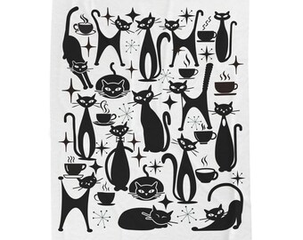 May include: A white blanket with a repeating pattern of black cat silhouettes, coffee cups, and starburst designs. The cats are in various poses, some standing, some sitting, and some stretching. The blanket has a retro, mid-century modern aesthetic.