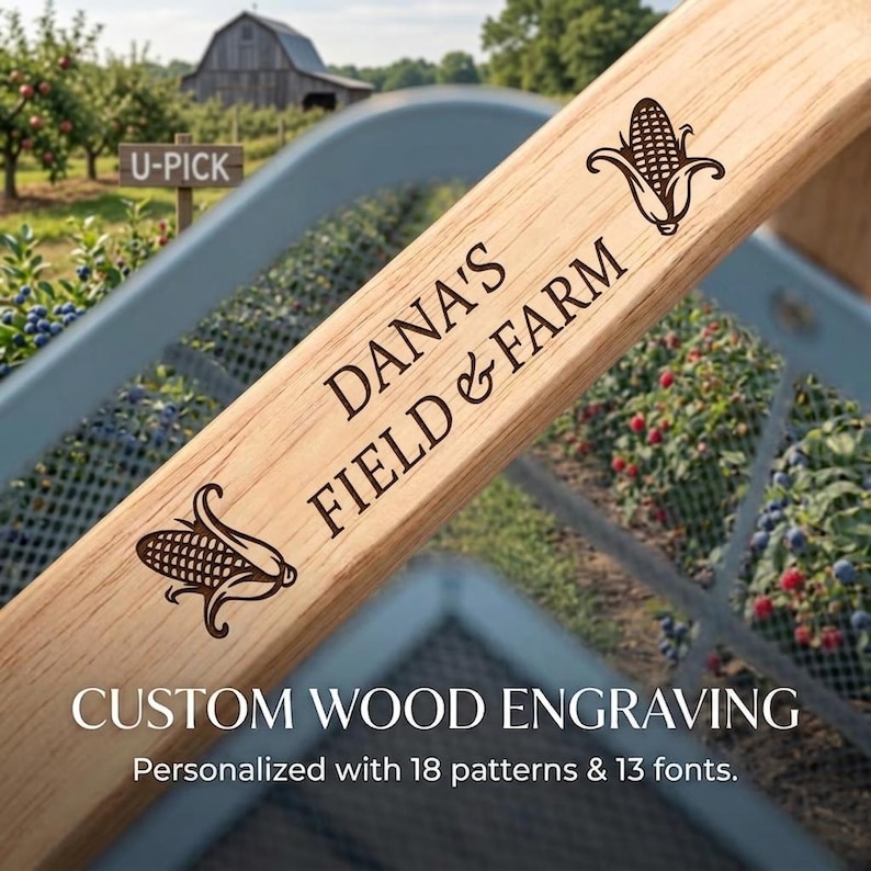 May include: A light-colored wooden plank featuring a custom laser engraving that reads DANA'S FIELD & FARM, flanked by two corn cob illustrations. The wood grain is visible, and the text is oriented diagonally across the surface of the board.