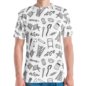 May include: White t-shirt with a repeating black pattern of various objects, including ladders, barbed wire, and brass knuckles. The shirt has short sleeves and a crew neck. The person is wearing blue jeans.