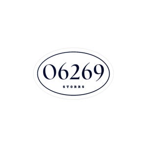 May include: An oval sticker with the number "06269" in a navy blue font, with the word "STORRS" below it. The sticker has a white background and a navy blue border.