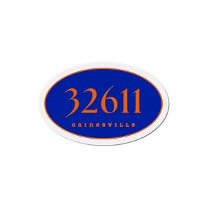 Puede incluir: Pegatina ovalada con fondo azul y borde naranja. El número "32611" está en naranja, con "Gainesville" en letras naranjas debajo.