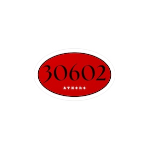 Peut inclure: Un autocollant ovale rouge avec le numéro "30602" en noir et le mot "Athens" en lettres noires plus petites en dessous. L'autocollant a une bordure blanche et est sur fond blanc.