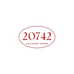 May include: An oval sticker with a red border and text. The number "20742" is in a bold, red font at the top, with "COLLEGE PARK" in a smaller, red font below. The sticker is set against a white background.