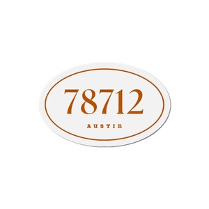 以下が含まれることがあります： 白地の楕円形のステッカーで、茶色の縁取りがあります。「78712」の数字が茶色で表示され、その下に「AUSTIN」が小さなフォントで印刷されています。ステッカーは車やその他の表面用に設計されています。