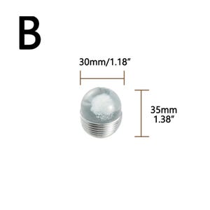 K&ouml;nnte beinhalten: Ein klares, kugelf&ouml;rmiges Objekt mit wei&szlig;em Innenraum, das auf einer silbernen, geriffelten Basis steht. Das Objekt ist 30 mm breit und 35 mm hoch. Der Buchstabe "B" befindet sich in der oberen linken Ecke.