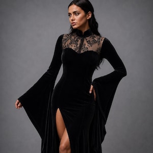 May include: A black velvet floor-length dress featuring long flared sleeves, a high collar, and a sheer lace panel across the upper chest and shoulders. The garment includes a fitted bodice and a high thigh-high slit along the front skirt.