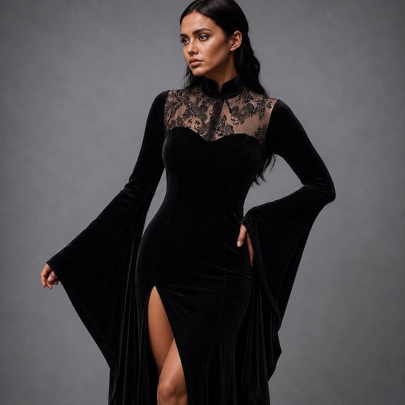 May include: A black velvet floor-length dress featuring long flared sleeves, a high collar, and a sheer lace panel across the upper chest and shoulders. The garment includes a fitted bodice and a high thigh-high slit along the front skirt.