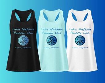May include: Three tank tops in black, light blue, and white, each featuring the text "Lake Natoma Paddle Club" and a circular logo with paddles and the number "916". The text "Folsom, California" is below the logo.