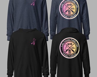 May include: Four long-sleeved hoodies in navy blue and black. Each hoodie features a pink paddleboard and paddle graphic on the front. The back of the navy blue and black hoodies display a circular logo with text: "Lake Natoma Paddle Club, 916, Folsom, California."