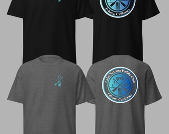 May include: Black and charcoal gray t-shirts with a paddleboard graphic on the front and a Lake Natoma Paddle Club logo on the back. The logo features text that reads "Lake Natoma Paddle Club 916 Folsom, California."