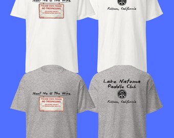 May include: White and grey t-shirts with front and back designs. The front of the shirts read "Meet Me @ The Wire" and "Folsom State Prison No Trespassing". The back of the shirts read "Lake Natoma Paddle Club" and "Folsom, California".