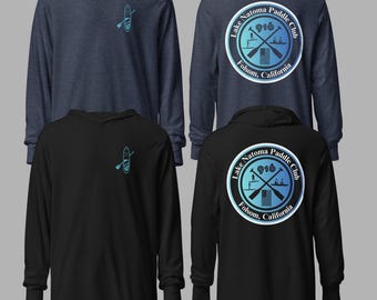 May include: Long-sleeve hooded shirts in navy blue and black. Each shirt features a teal paddle graphic on the front and a circular logo on the back that reads "Lake Natoma Paddle Club 916 Folsom, California."