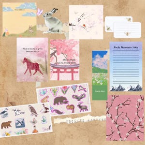 Peut inclure: Un collage d'articles de papeterie sur le thème de la nature. Comprend des blocs-notes, des autocollants et des cartes avec des illustrations de lapin, de fleurs et d'animaux. Le texte "Notes in Bloom", "What is meant to grow, does not hurry", "Bloom gently, you're getting there", et "Rocky Mountain Notes" est visible.