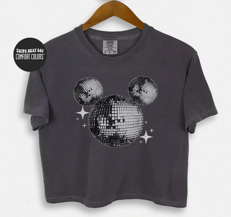 A gray t-shirt with a graphic design of three disco balls and stars on the front.