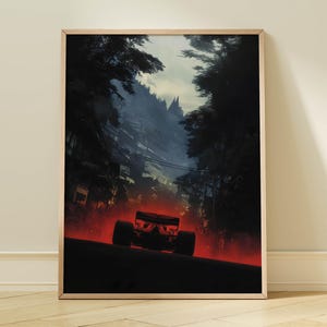 May include: Framed art print depicting a Formula 1 car racing through a forest. The artwork uses a dark colour palette with a red glow from the car, set against a backdrop of trees and a dusky sky, creating a dramatic scene.