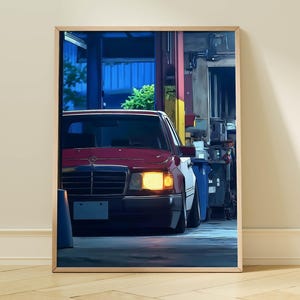 May include: Framed print of a vintage red car with its headlights on, parked in a garage setting. The car's front is centered, showcasing its grill and bumper. The background includes industrial elements and a blue-lit area.