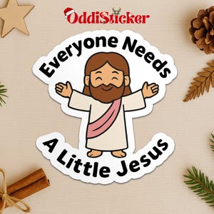 May include: A white sticker with a cartoon illustration of Jesus with outstretched arms. The text "Everyone Needs A Little Jesus" is in a circular design around the image. The sticker has a white border and a festive design.