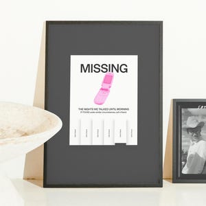 May include: A framed print with the word "MISSING" in bold black letters above a pink flip phone illustration. Below, text reads "THE NIGHTS WE TALKED UNTIL MORNING" and "IF FOUND under similar circumstances, call a friend."