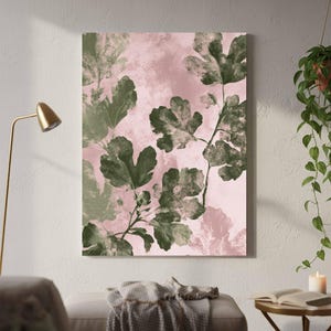 May include: A rectangular wall art print featuring a botanical illustration of dark green fig leaves set against a soft, pale pink background. The artwork displays a textured, layered appearance with visible leaf veins and organic shapes.